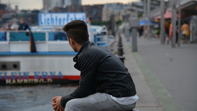A young man sitting by the harbour. Picture: Pixabay.