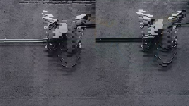 Security cameras on a grey concrete wall
