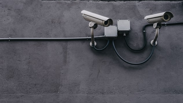 Security cameras on a grey concrete wall